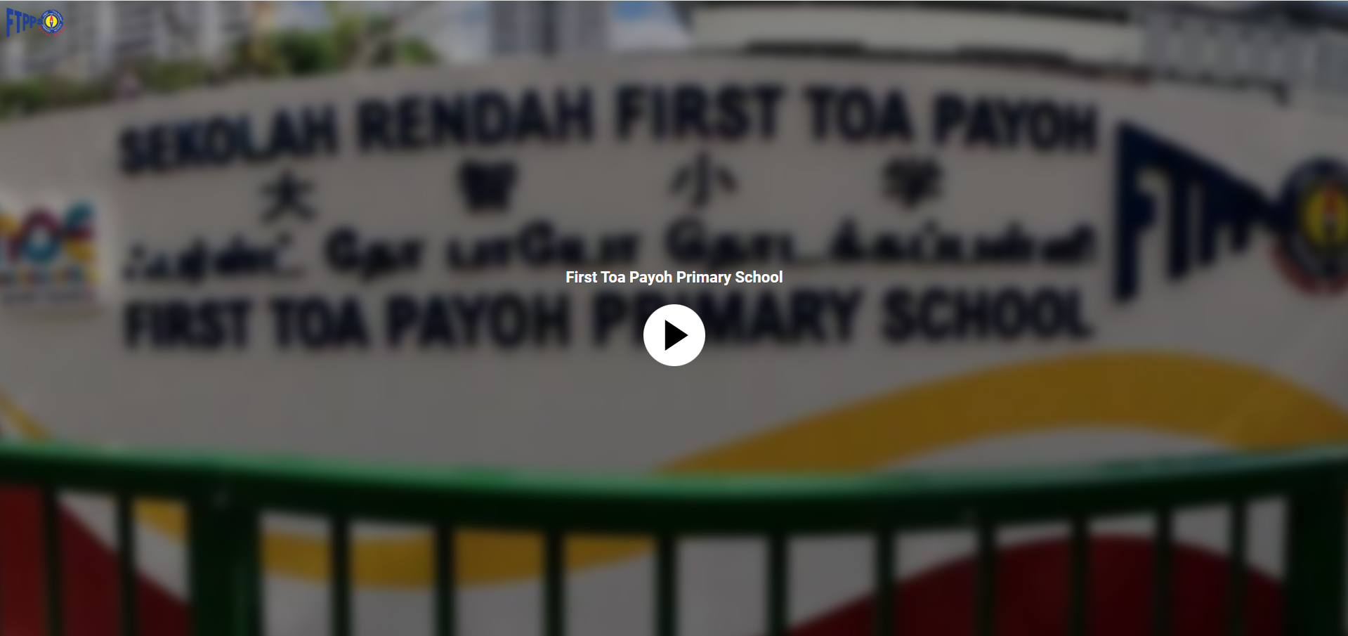 Video thumbnail showing the sign of First Toa Payoh Primary School with multilingual text and a play button overlay.